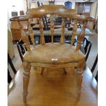 A 19th Century stained wood framed bow elbow chair with solid moulded seat, set on turned front