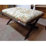 A 3' 7 1/2" antique stained oak X-frame dressing stool with overstuffed seat, set on associated