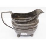 A Georgian silver cream jug with reeded band decoration - London 1809