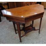 A 34" late Victorian stained oak fold-over octagonal topped card table set on square tapered