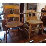 A 19th Century stained elm elbow chair with solid seat, set on ring turned supports - sold with an