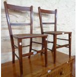 A pair of Edwardian walnut and strung framed bedroom chairs with rattan seat panels