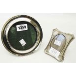 A small circular silver fronted photograph frame with polished oak easel back - sold with another