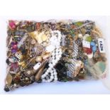 A bag containing a large quantity of assorted costume jewellery