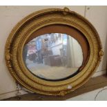 An antique later gilded oval wall mirror with replacement plate