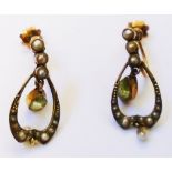 A pair of Edwardian yellow metal screw ear-rings, each set with pendant peridot drop and seed