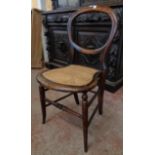 A pair of Victorian simulated rosewood framed balloon back bedroom chairs with rattan seat panels,
