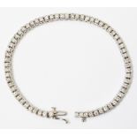 A hallmarked 750 white gold bracelet, set with numerous collar set diamonds