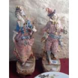 A pair of continental figures - one with damaged hand