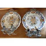 A pair of Italian ceramic wall plaques with fitted pewter sconces