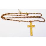A hallmarked 9ct. gold engraved cross on rose metal chain