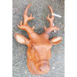 A wall hanging cast iron stag's head