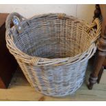 A large wicker two handled log basket
