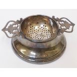 A silver tea strainer and stand - Birmingham 1967