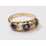 An 18ct. gold ring, set with three sapphires interspersed with two diamonds - Birmingham 1908