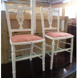 A pair of later painted Edwardian pierced splat back bedroom chairs