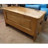A 35 1/2" modern waxed pine blanket chest with panelled front and flanking handles