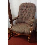 A Victorian stained walnut framed drawing room armchair with button back upholstery, set on turned