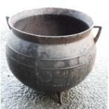 A cast iron cauldron with flanking handles