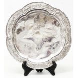 An 8 1/2" diameter Chinese white metal petal shaped salver with bamboo pattern cast rim, birds,