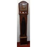 An early 20th Century polished oak and beaded cased granddaughter clock with glazed panel to trunk