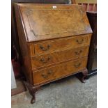 A 30" reproduction figured walnut bureau with part fitted interior and three long graduated