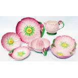 Six pieces of Carltonware buttercup pattern on pink ground including lemon squeezer, jug, bowls,