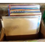 A box containing a collection of vinyl LPs records including 'In Through the Out Door' and 'II' by