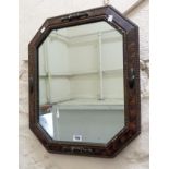 A painted framed and beaded octagonal wall mirror