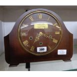 A polished walnut cased mantel clock, bearing 1951 presentation plaque to dial centre with Smiths