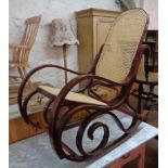 A modern stained bentwood rocking chair in the Victorian style with rattan back and seat panels