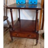 A 20" William IV mahogany two tier side table with turned supports and drawer under set on brass