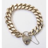 A heavy solid silver kerb-link bracelet with heart shaped padlock and safety chain