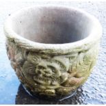 A concrete garden pot with floral decoration