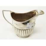 A small silver cream jug of semi reeded design - William Hutton & Sons, London 1897