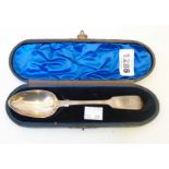 A cased Victorian silver fiddle pattern desert spoon with initials to terminal