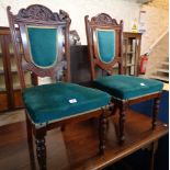 A set of four Edwardian walnut framed panel back dining chairs upholstered in blue/green velour, set