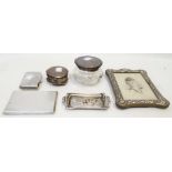 An Edwardian cherub decorated pin tray, two silver cigarette cases, dressing table jar and ring
