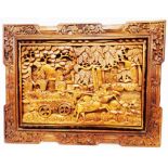A modern framed Balinese carved wood panel depicting Rama and Shinta in their carriage