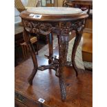 A 15" diameter antique Chinese export marble topped low table in the European taste with pierced