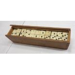 An antique boxed set of bone nine spot dominoes - one missing