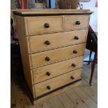 A 34" modern waxed pine and part ebonised chest of two short and four long graduated drawers, set on