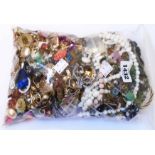 A bag containing a large quantity of assorted costume jewellery