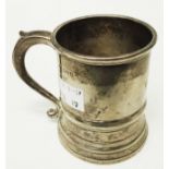 A silver christening mug with cast scroll handle and engraved initials