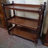 A 3' 5" late Victorian mahogany three tier buffet with moulded surfaces and reeded turned