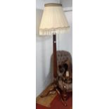A mahogany standard lamp with shade, reeded tapered pillar and tripod base