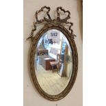 A Victorian cast brass framed small bevelled oval wall mirror with pierced bow pediment