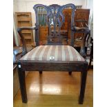 A late Georgian mahogany framed Chippendale style elbow chair with decorative acanthus pierced splat