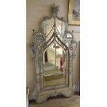 An Italian ornate wall mirror with profuse moulded glass florettes and C-scroll applied