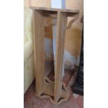 A 3' 1 1/4" stripped pine wall mounted book shelf with decorative pierced bracket ends